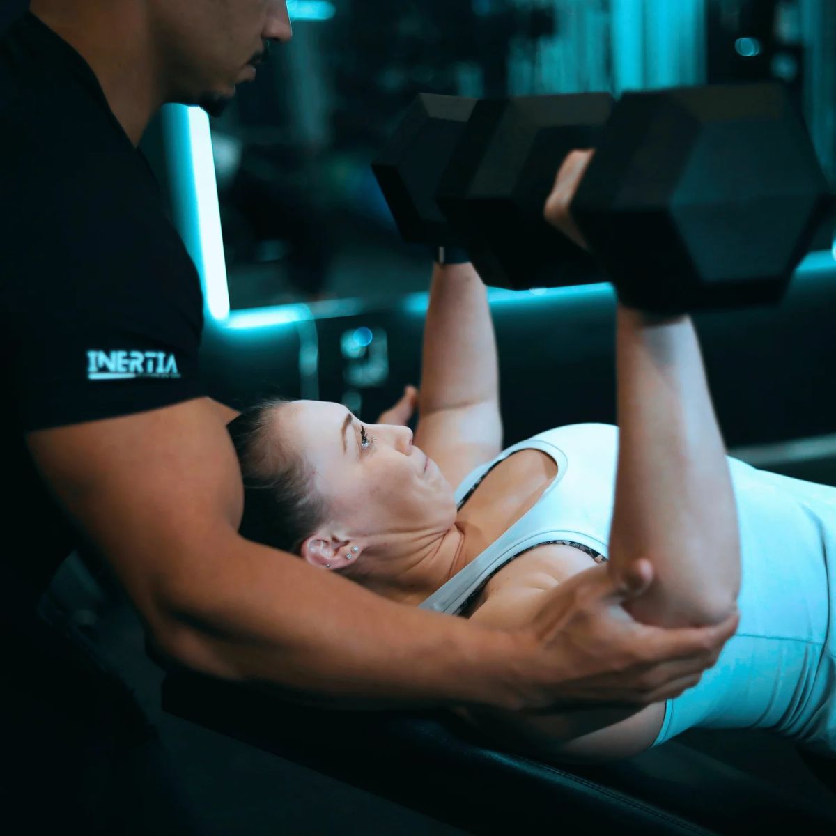 One-on-one dumbbell coaching inside the Uptown studio