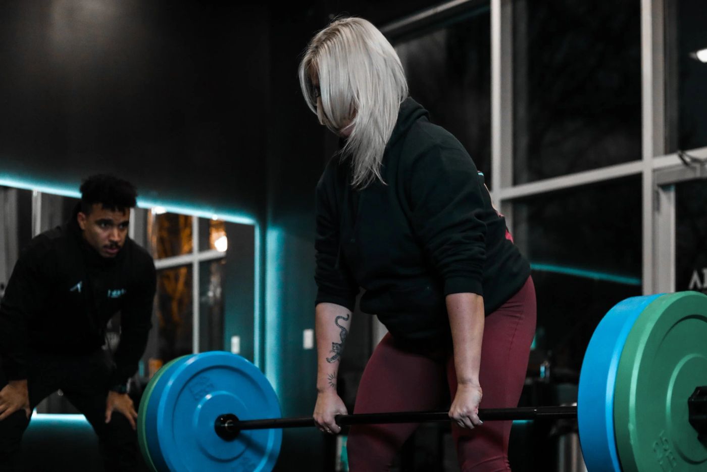 An Inertia coach spotting a client's deadlift at the Uptown Charlotte studio