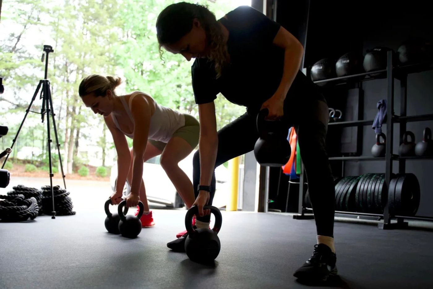 Two clients training with kettlebells at Inertia Fitness Co.