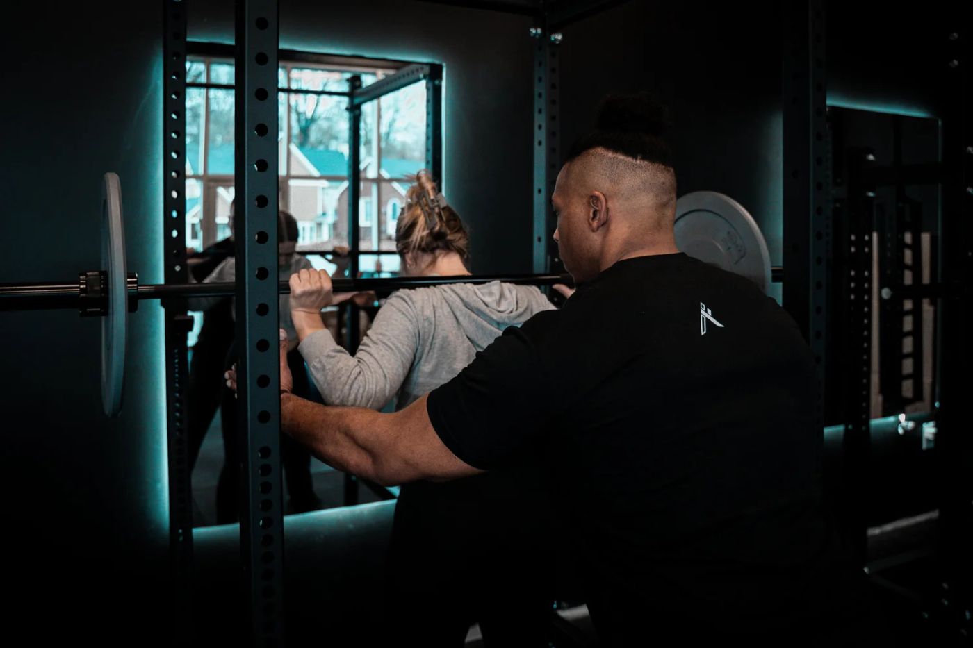 Coaching a squat inside the Inertia Fitness Co. Uptown Charlotte studio